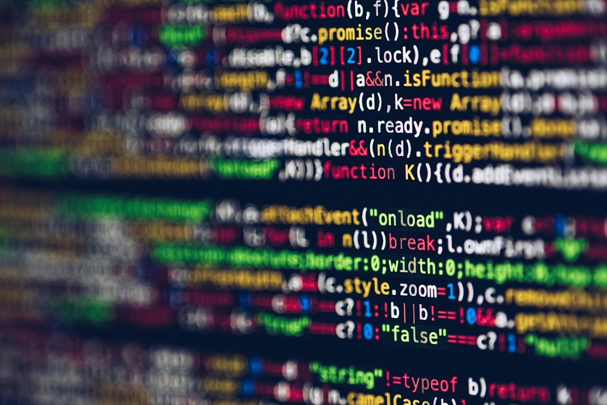 Blurred code representing app development services - ZeroMaze Agency